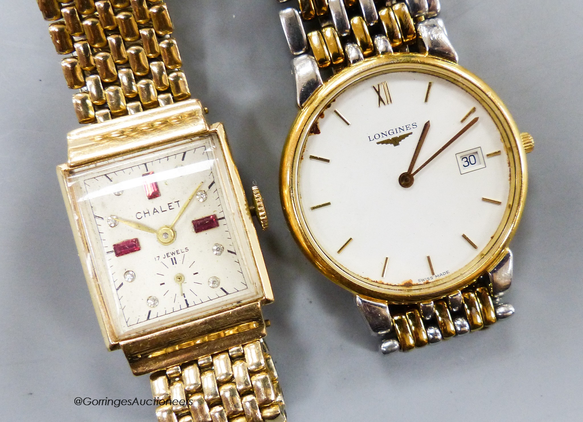 A lady's 14k yellow metal cased Chalet manual wind wrist watch, on a gold plated strap and a gentleman's steel and gilt Longines quartz wrist watch.